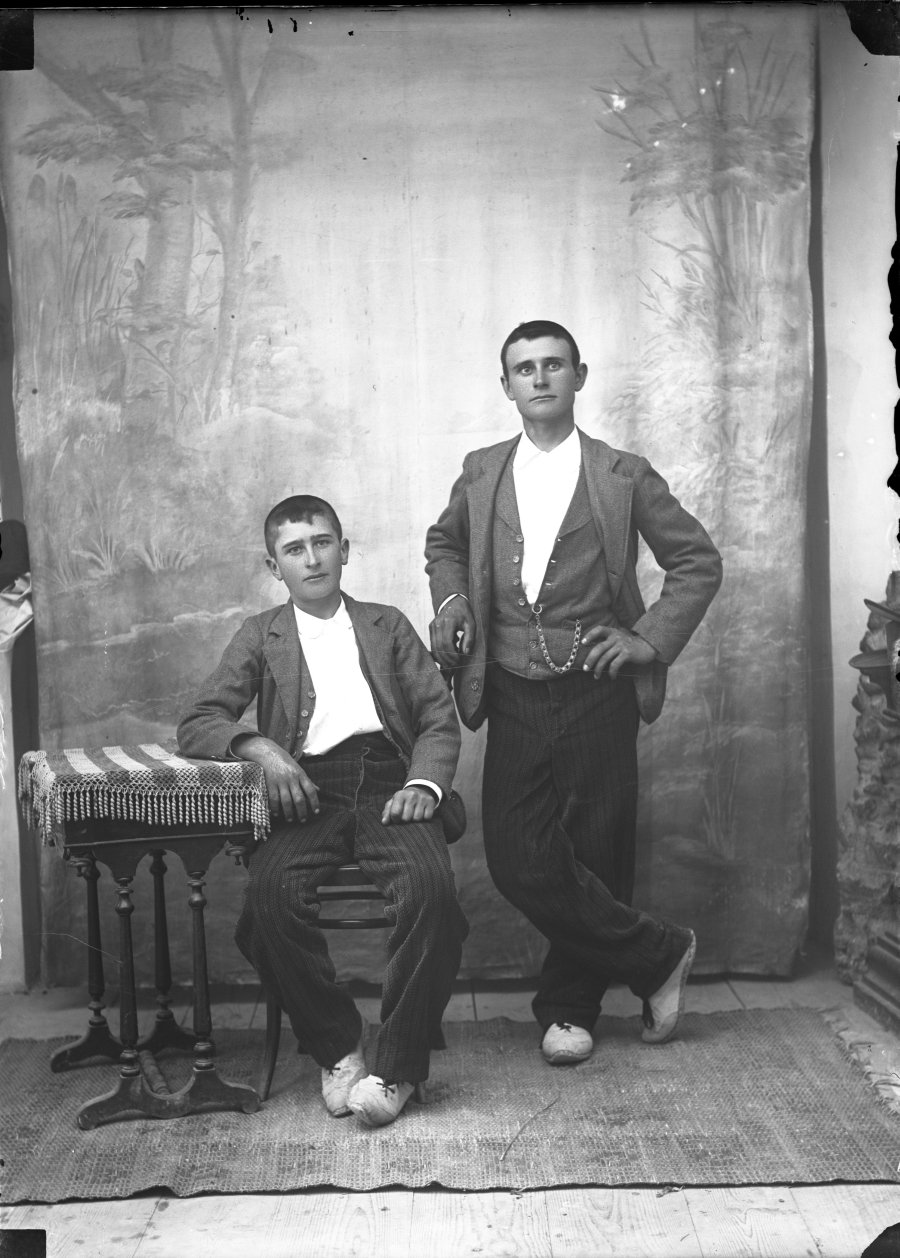Retrato de estudio de un hombre joven y un adolescente con la misma vestimenta