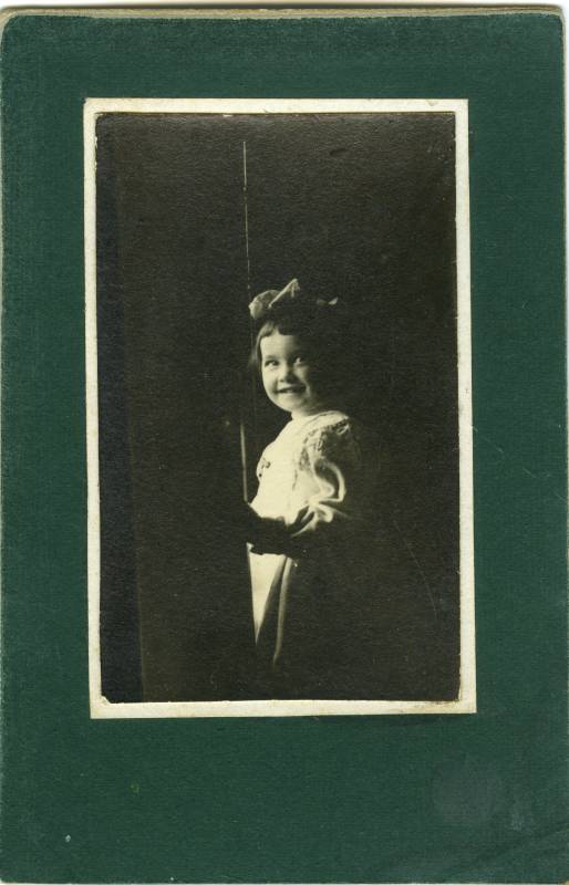 Retrato de una niña con lazo, en claroscuro.