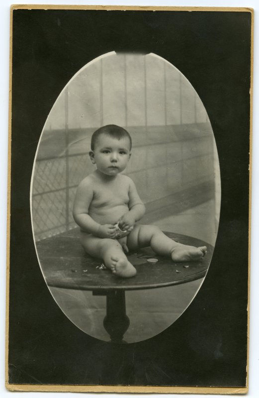 Retrato de bebé sentado sobre una mesa
