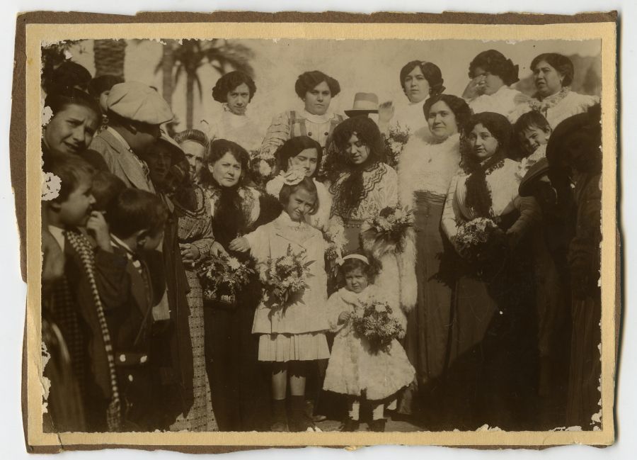Grupo de mujeres y niñas durante una ofrenda floral