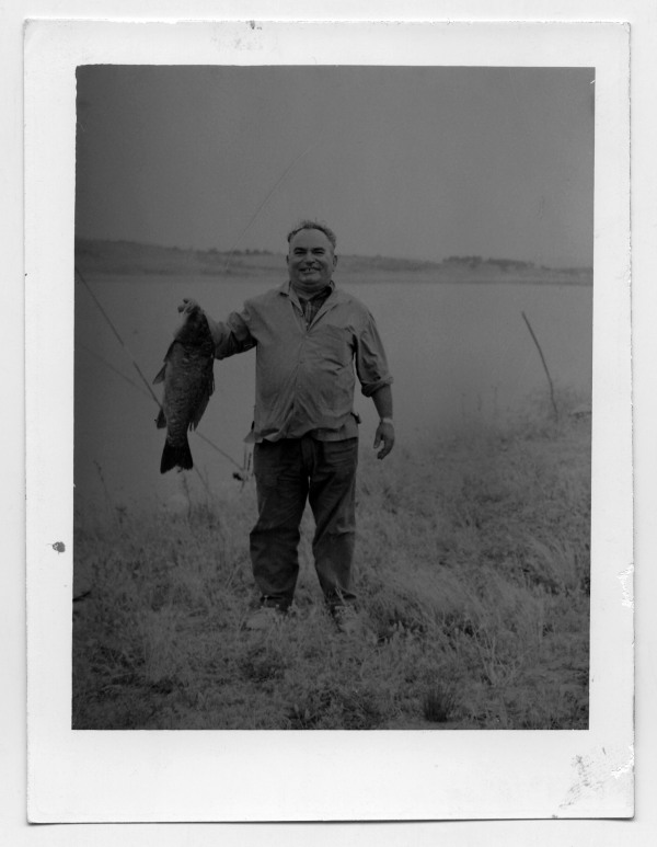 Retrato de Francisco Suárez mostrando un pescado junto al lago donde acaba de capturarlo